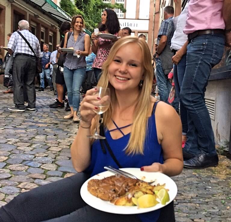 woman eating german food and drinking wine in Freiburg