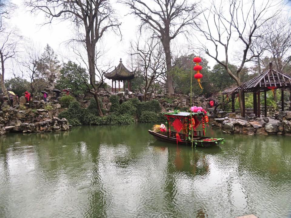Chinese traditional gardens in Suzhou with small boat