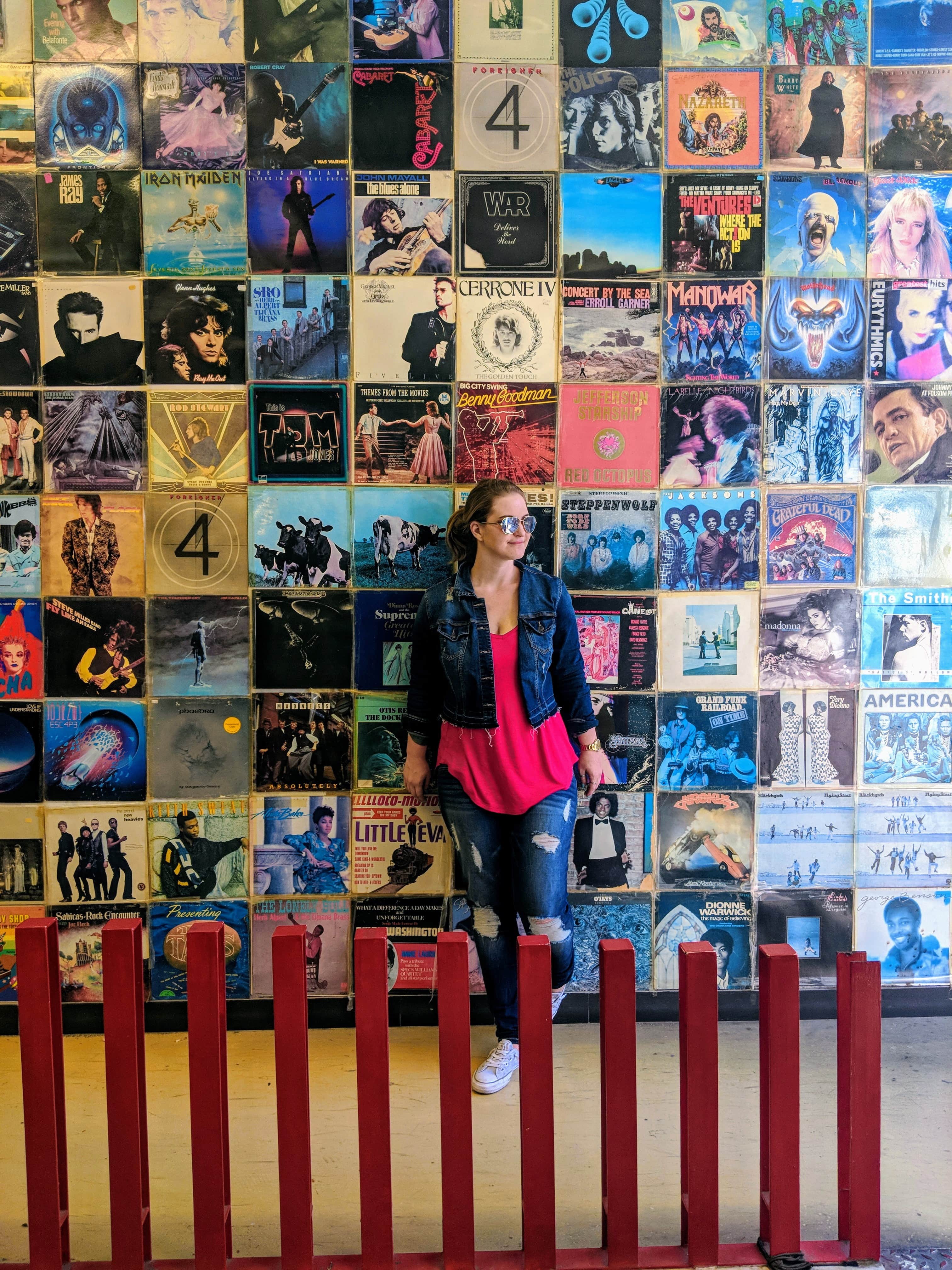 woman against wall of vinyls