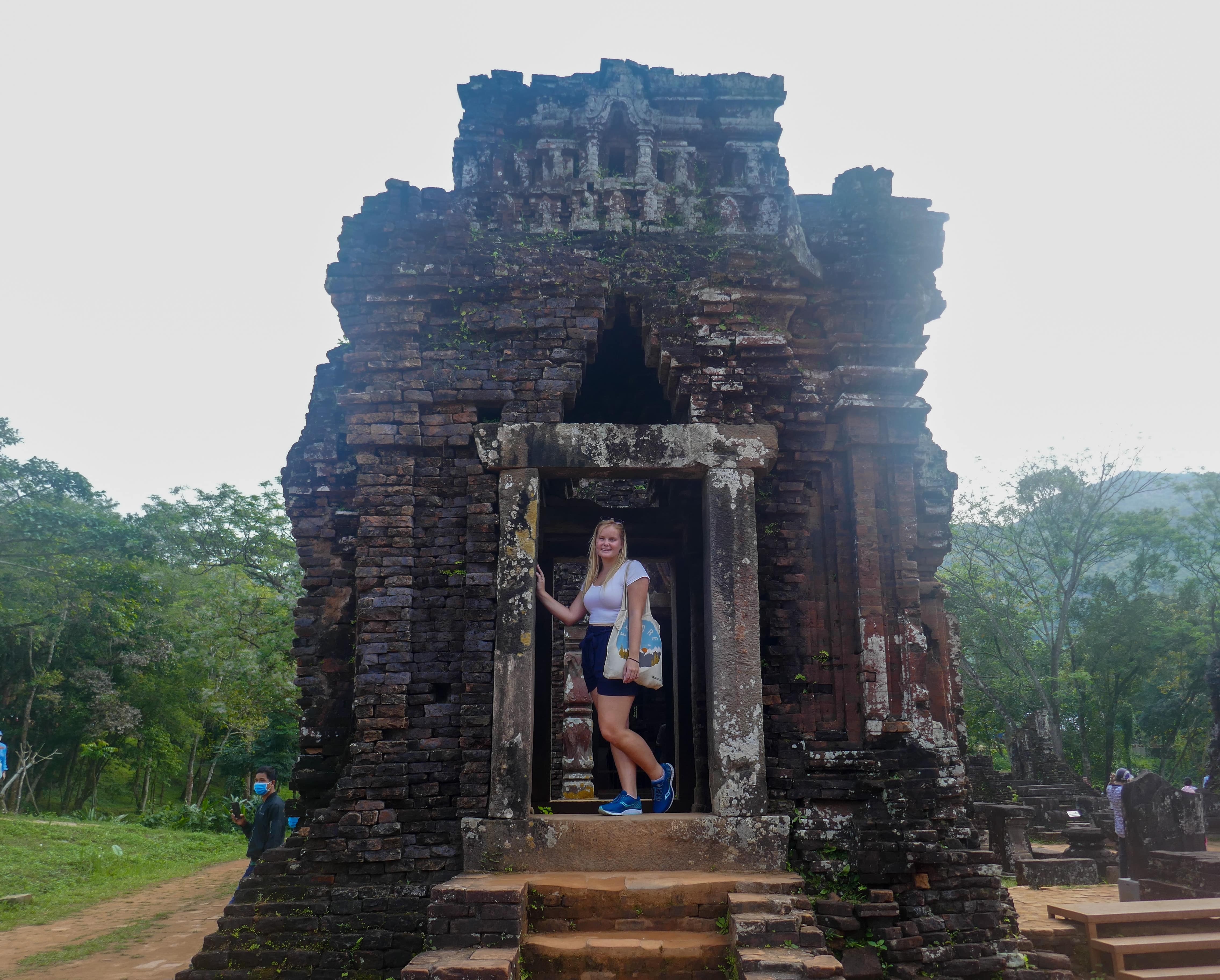woman smiling inside ruined temple